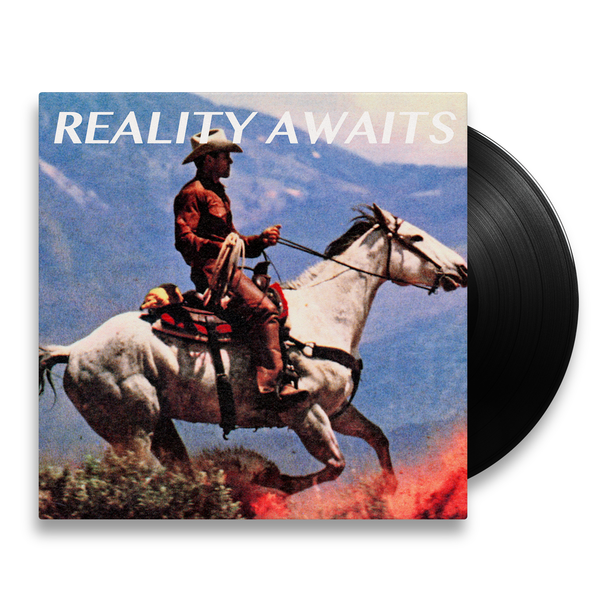 The Strokes Reality Awaits Vinyl record with a cowboy on a horse in front of a mountainous background. The Black Colored Vinyl is poking out of the packaging to showcase the color variant.