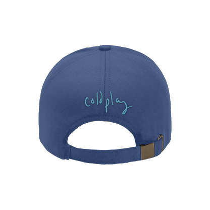 Back: COLDPLAY is embroidered in light blue thread on a soft grey-blue baseball cap, in Chris’s casual, flowing script.