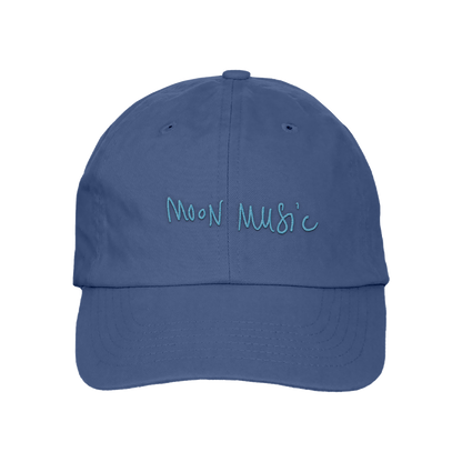 Front: a soft grey-blue baseball cap, with MOON MUSIC embroidered in Chris’s playful, light blue handwritten-style. The letters are slightly uneven, giving it a casual and artistic feel