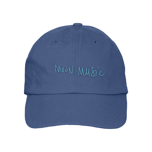 Front: a soft grey-blue baseball cap, with MOON MUSIC embroidered in Chris’s playful, light blue handwritten-style. The letters are slightly uneven, giving it a casual and artistic feel