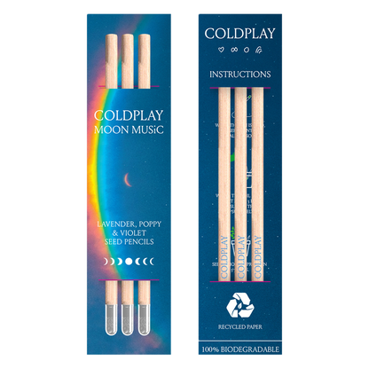 Package view from 2 sides. Front: a??&a large arced rainbow light dispersion to the right. Colors flow from red to orange, yellow, green, light&dark blue, fading into deep blue background. Text reads: COLDPLAY, MOON MUSIC, LAVENDER, POPPY&VIOLET SEED PENCILS. There’s a 7-phase moon cycle from??to??in the center, back to?? The back of the package reads: COLDPLAY, with a ????a circle&Chris’s rainbow doodle. Text, moons&symbols are white. Instructions,??RECYCLED PAPER, 100%BIODEGRADABLE, package has 3 pencils