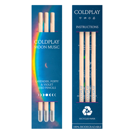 Package view from 2 sides. Front: a??&a large arced rainbow light dispersion to the right. Colors flow from red to orange, yellow, green, light&dark blue, fading into deep blue background. Text reads: COLDPLAY, MOON MUSIC, LAVENDER, POPPY&VIOLET SEED PENCILS. There’s a 7-phase moon cycle from??to??in the center, back to?? The back of the package reads: COLDPLAY, with a ????a circle&Chris’s rainbow doodle. Text, moons&symbols are white. Instructions,??RECYCLED PAPER, 100%BIODEGRADABLE, package has 3 pencils