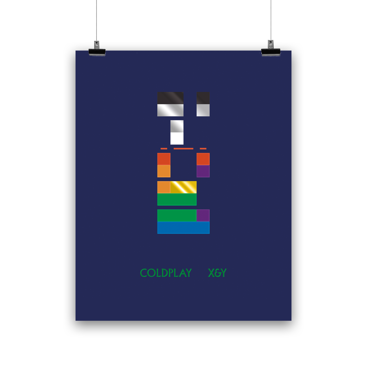 Image 1:
Multicolored blocks, like a puzzle of domino pieces, signify binary code. A square means 1; a gap means 0. When decoded, it reads X&Y. Below, X&Y and Coldplay are written in bright green. Colors of the blocks include Black, gray, red, orange, green, white, blue, yellow and violet, on a dark blue background