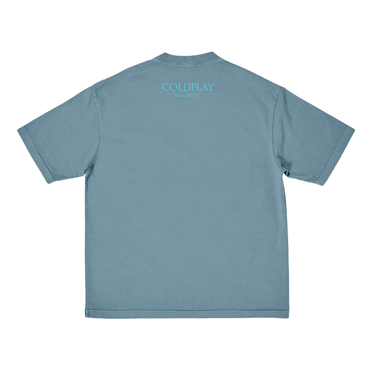 Back: COLDPLAY is printed in light blue, in a slightly lighter shade than the fabric of the shirt. Moon Music is hand-written below. COLDPLAY is larger than Moon Music.