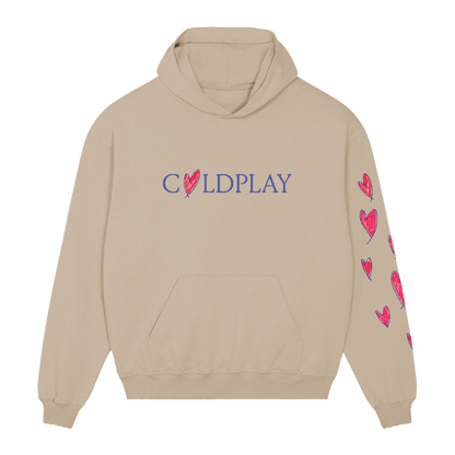 Front: Light beige hoodie. COLDPLAY is printed across the chest in purple, with a hand-drawn heart making the letter O; The heart’s outline is purple, filled in with pink fuchsia. Chris’s hand-drawn hearts run vertically down the left sleeve. All hearts are pink fuchsia, but outlined in purple. They’re different sizes, some thicker, some thinner, some slightly tilted, creating a playful pattern. The hoodie has a large front pocket.