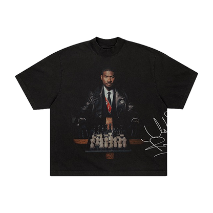 Black t-shirt with a graphic of Usher in a suit and tie, chessboard, and signature 