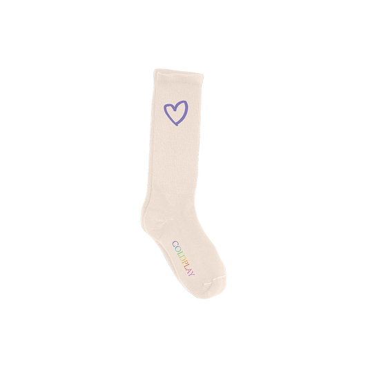 Heart Logo Socks: Cream colored crew socks which rise above the ankle, with a purple heart near the top and COLDPLAY printed on the foot in a gradient of rainbow colors: M is purple, first O is light blue, second O is green, N is green to yellow, M is orange, U is red, S is pink, I is pink, and C is light purple.