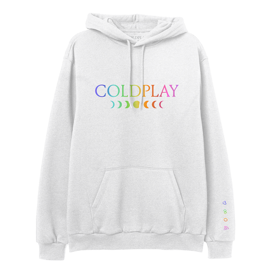 Front: COLDPLAY printed on chest in rainbow gradient. C is purple, O is light blue, L is green, D is green to yellow, P is orange, L is dark orange, A is bright pink, and Y is a muted pink. A 7-phase moon cycle sits below in a matching gradient. A purple heart, green infinity sign, orange circle, and pink rainbow sit vertically on the left sleeve beginning at the wrist.
